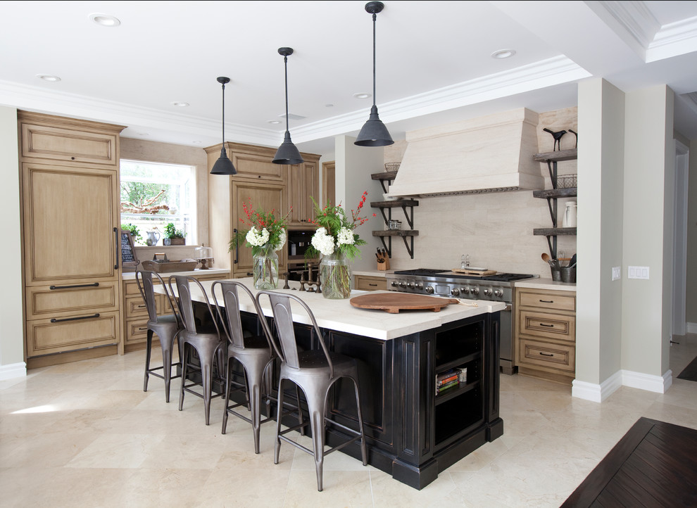 Large transitional u-shaped open plan kitchen in Orange County with recessed-panel cabinets, limestone benchtops, beige splashback, with island, a double-bowl sink, medium wood cabinets, limestone splashback, stainless steel appliances, porcelain floors, beige floor and beige benchtop.