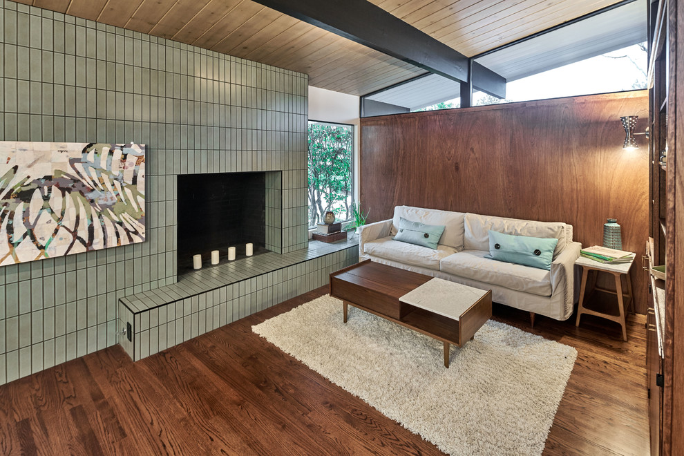 Design ideas for a mid-sized midcentury formal open concept living room in San Francisco with brown walls, medium hardwood floors, a standard fireplace, a tile fireplace surround, no tv and brown floor.