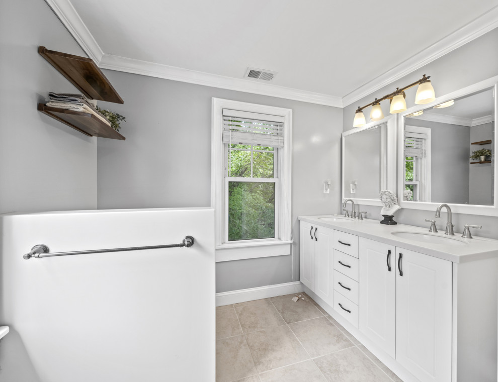 This is an example of a large country master bathroom in DC Metro with a corner shower, ceramic floors, a hinged shower door, a double vanity and a built-in vanity.