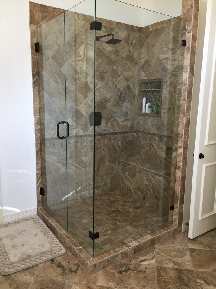 Design ideas for a mid-sized traditional master bathroom in Dallas with raised-panel cabinets, beige cabinets, a corner tub, a corner shower, white walls, ceramic floors, an undermount sink, limestone benchtops and a hinged shower door.