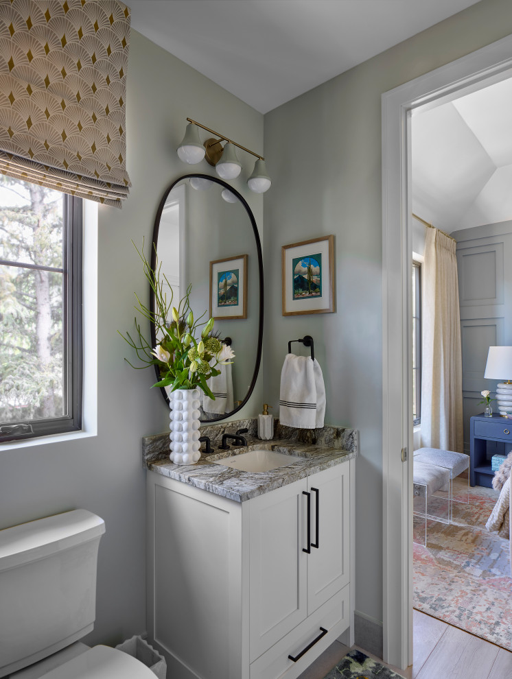 Mid-sized transitional black tile and ceramic tile light wood floor powder room photo in Denver with shaker cabinets, white cabinets, a two-piece toilet, green walls, a drop-in sink, granite countertops, green countertops and a built-in vanity