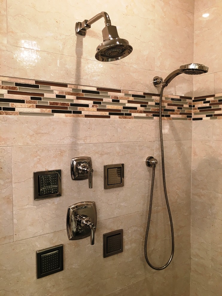 This is an example of a large contemporary master bathroom in Austin with a corner shower, beige tile and porcelain tile.