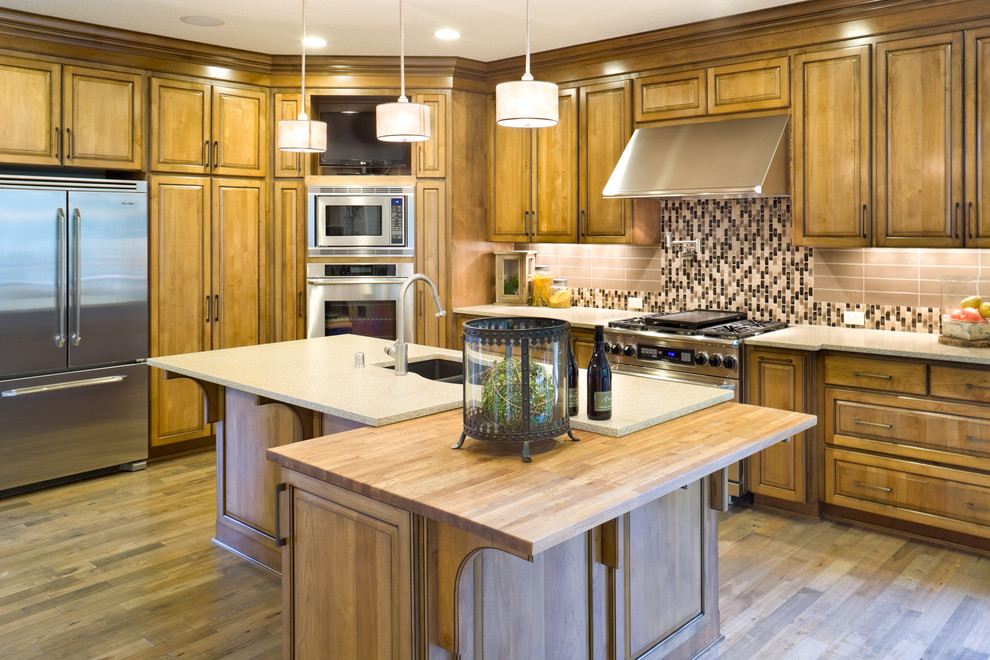 This is an example of a traditional kitchen in Portland with stainless steel appliances and wood benchtops.