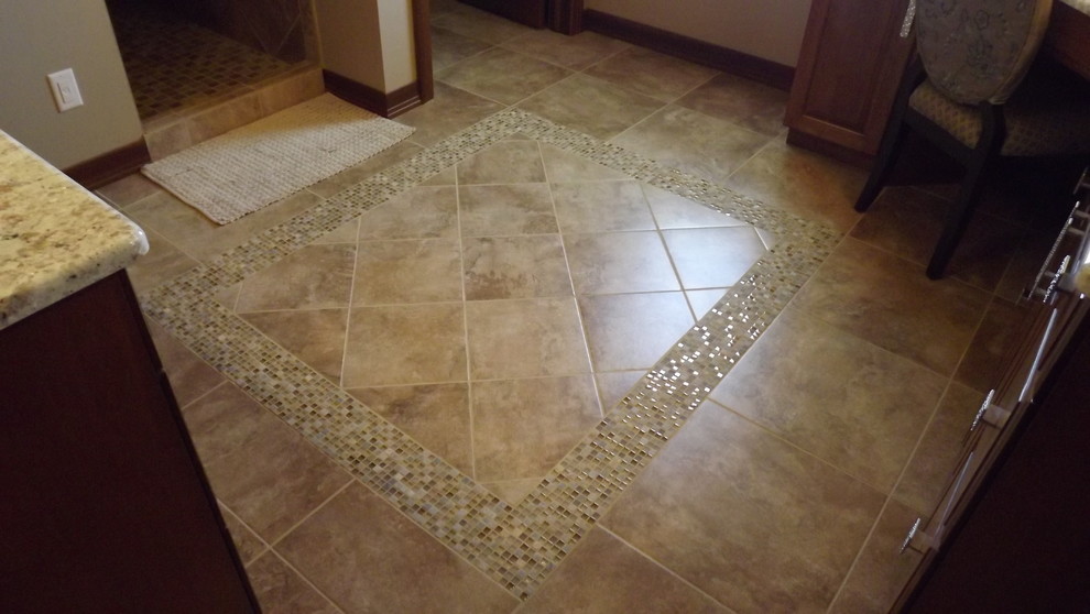 Inspiration for a transitional beige tile and porcelain tile porcelain tile doorless shower remodel with an undermount sink, raised-panel cabinets, medium tone wood cabinets, granite countertops and beige walls