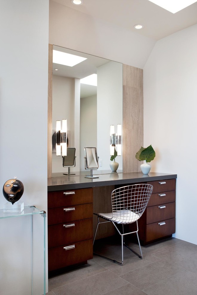 Inspiration for a large contemporary master bathroom in Los Angeles with an undermount sink, flat-panel cabinets, dark wood cabinets, solid surface benchtops, a freestanding tub, gray tile, white walls, a one-piece toilet, porcelain tile, porcelain floors and grey floor.
