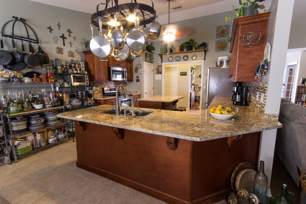 Example of a mid-sized galley cement tile floor and beige floor eat-in kitchen design with an undermount sink, shaker cabinets, medium tone wood cabinets, granite countertops, multicolored backsplash, glass sheet backsplash, stainless steel appliances, an island and beige countertops