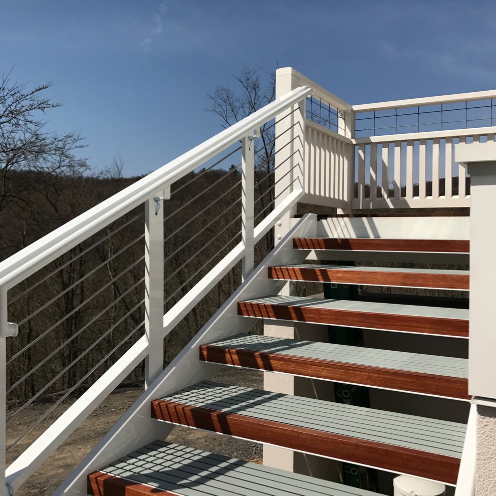 Inspiration for a mid-sized transitional backyard deck remodel with no cover