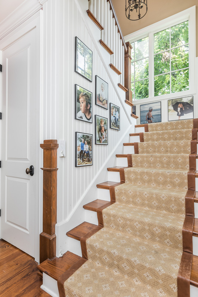 Design ideas for a mid-sized traditional wood staircase.