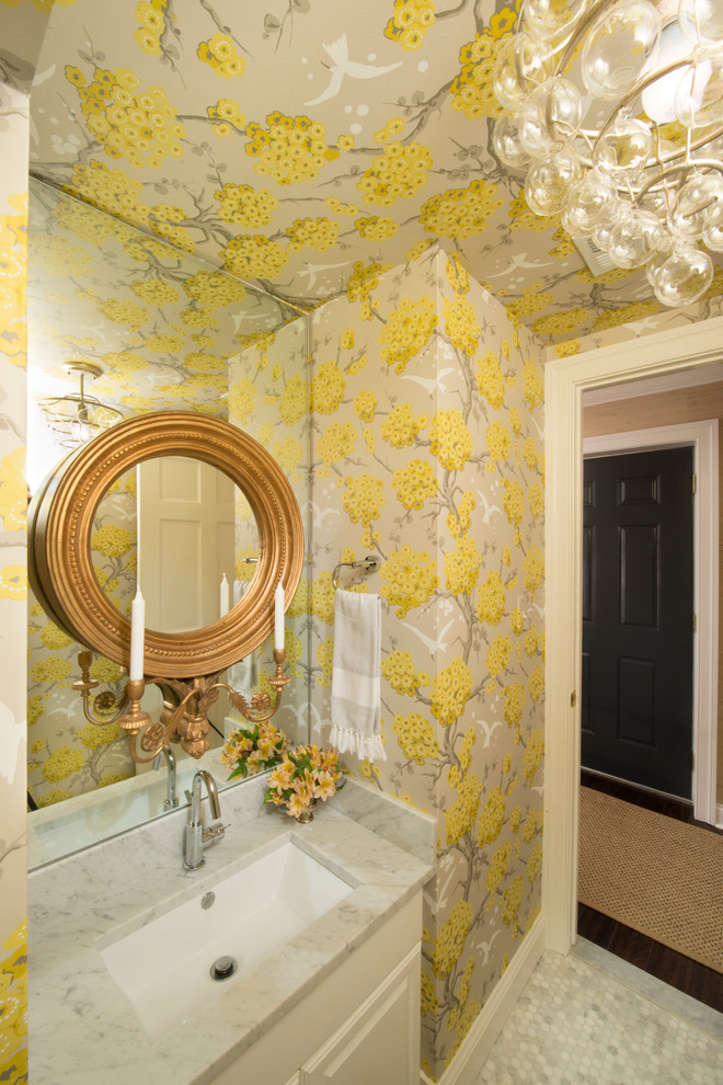Design ideas for a small transitional powder room in Baltimore with an undermount sink, raised-panel cabinets, white cabinets, marble benchtops, gray tile, yellow walls and marble floors.