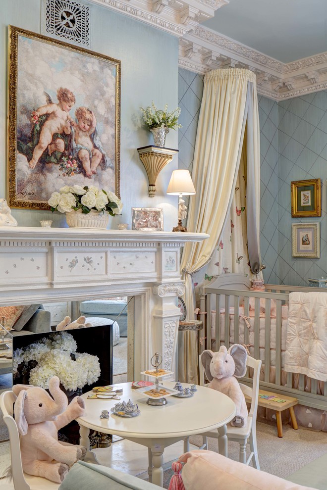 This is an example of a large traditional nursery for girls in New York with blue walls, carpet and beige floor.