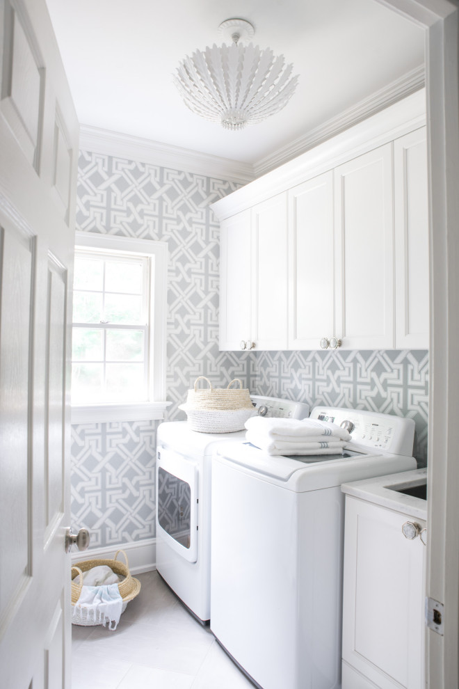 Design ideas for a transitional dedicated laundry room in Charlotte with an undermount sink, recessed-panel cabinets, white cabinets, grey walls, a side-by-side washer and dryer and grey floor.