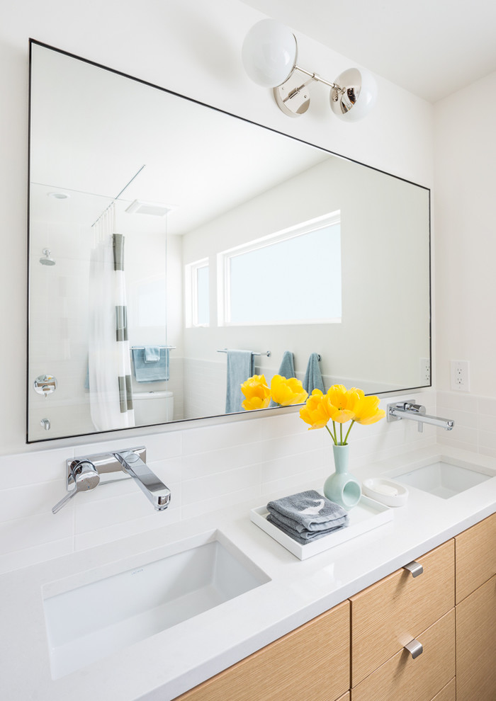 Design ideas for a mid-sized midcentury master bathroom in Seattle with flat-panel cabinets, light wood cabinets, an open shower, white tile, subway tile, white walls, porcelain floors, an integrated sink and engineered quartz benchtops.
