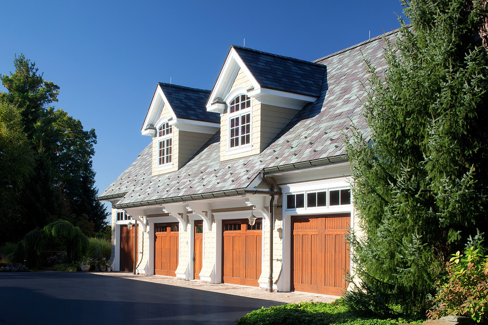 Photo of an expansive traditional detached four-car garage in Grand Rapids.