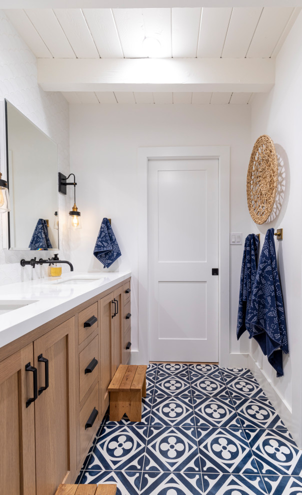 Design ideas for a nautical bathroom in Los Angeles with shaker cabinets, medium wood cabinets, white walls, a submerged sink, multi-coloured floors, white worktops, double sinks and a built in vanity unit.