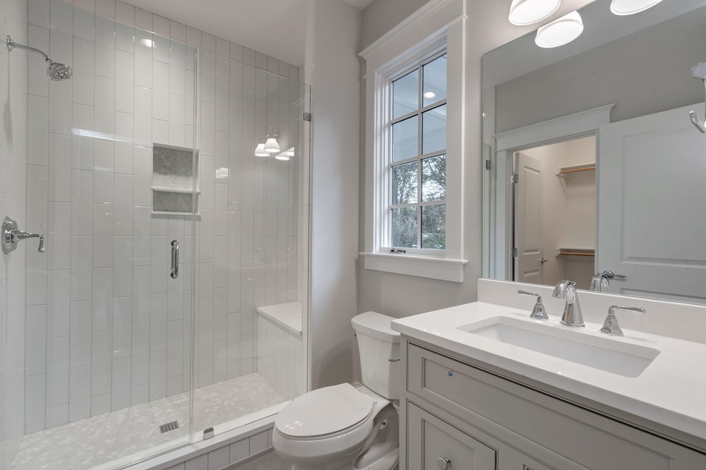 Inspiration for a mid-sized country 3/4 bathroom in DC Metro with beige cabinets, an alcove shower, a two-piece toilet, white tile, subway tile, beige walls, an undermount sink, quartzite benchtops and recessed-panel cabinets.