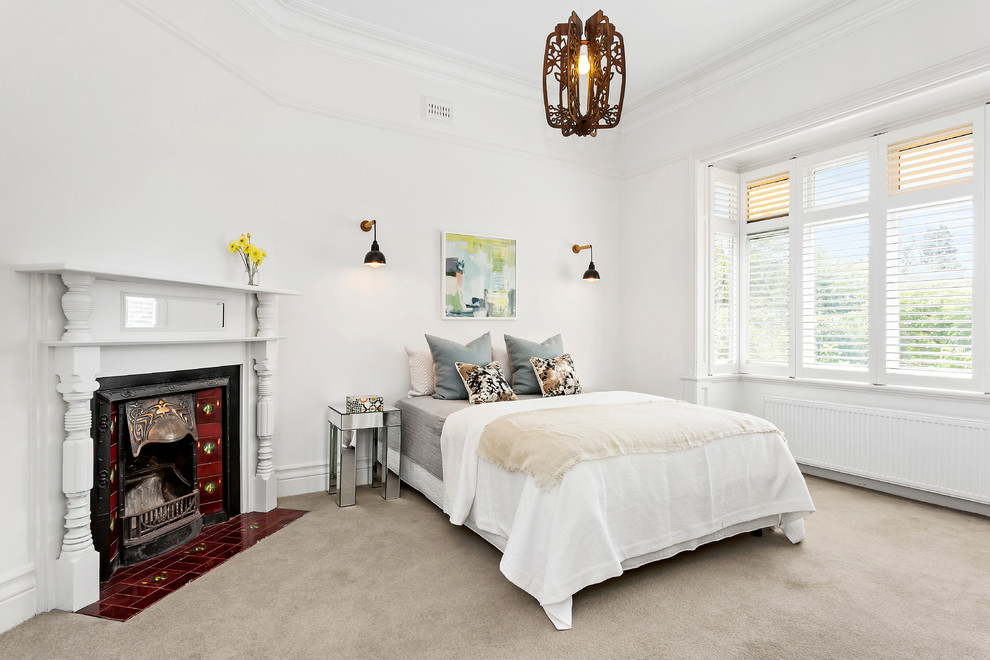 This is an example of a mid-sized transitional bedroom in Melbourne with white walls, carpet and beige floor.