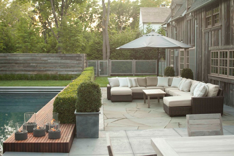 This is an example of a mid-sized contemporary backyard patio in New York.
