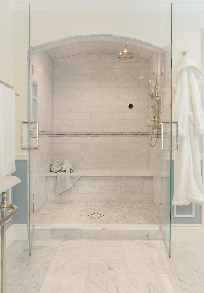 This is an example of an expansive traditional master bathroom in Los Angeles with open cabinets, a freestanding tub, an alcove shower, gray tile, stone tile, white walls, marble floors, a pedestal sink and solid surface benchtops.