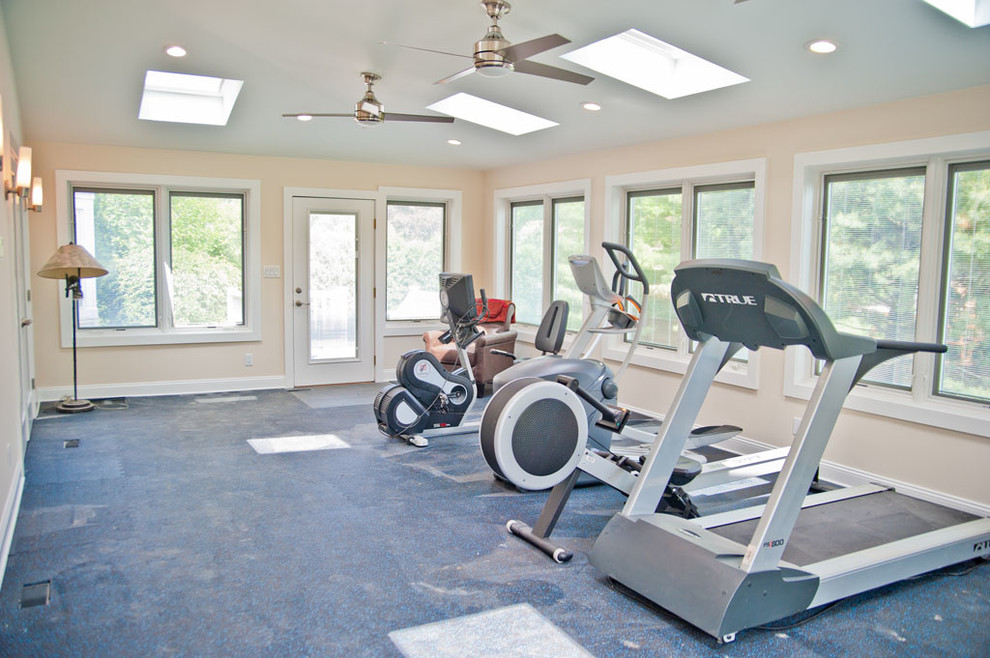 This is an example of a large contemporary multipurpose gym in New York with white walls and concrete floors.
