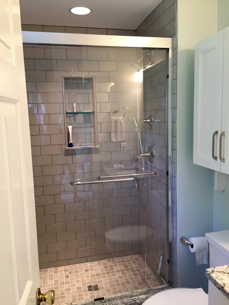 Alcove shower - small transitional master gray tile and porcelain tile porcelain tile alcove shower idea in DC Metro with shaker cabinets, white cabinets, a two-piece toilet, green walls, an undermount sink and quartz countertops
