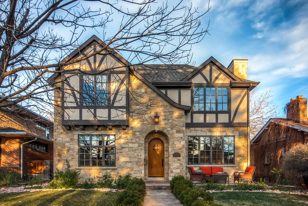 Design ideas for a large transitional two-storey beige exterior in Denver with stone veneer and a gable roof.