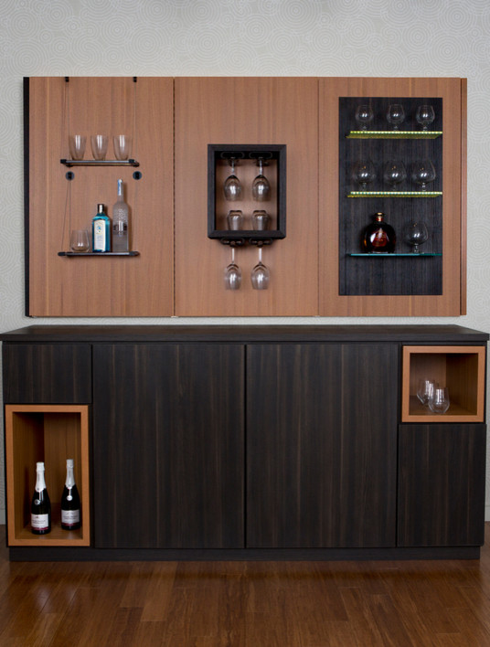 Inspiration for a mid-sized contemporary single-wall wet bar in Charleston with no sink, flat-panel cabinets, solid surface benchtops, timber splashback, travertine floors, beige floor, dark wood cabinets and brown splashback.