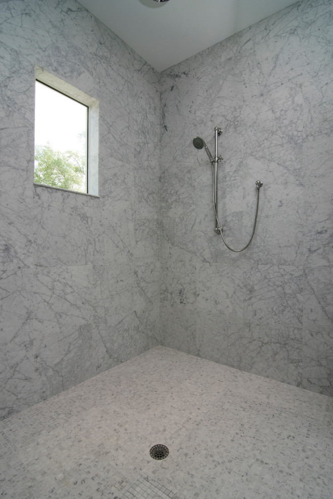 Example of a large transitional master gray tile, white tile and stone slab marble floor and gray floor freestanding bathtub design in Tampa with recessed-panel cabinets, white cabinets, white walls, a wall-mount sink, marble countertops and a hinged shower door