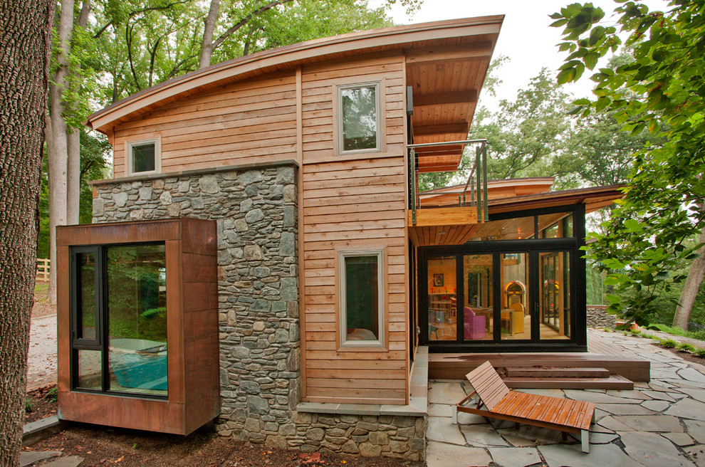 Example of a mountain style multicolored two-story mixed siding house exterior design in DC Metro with a metal roof