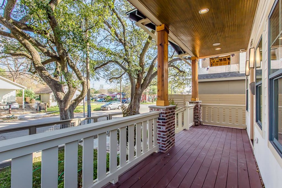Photo of a mid-sized arts and crafts front yard verandah in Houston with decking and a roof extension.