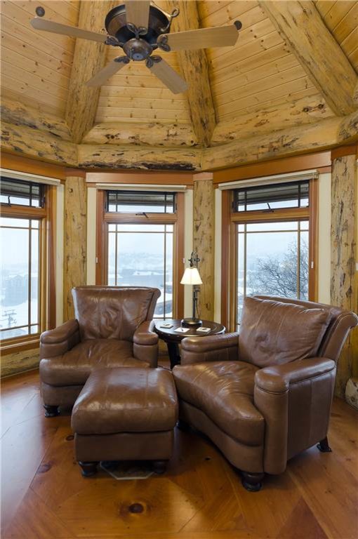 Design ideas for a mid-sized country enclosed family room in Denver with a game room, brown walls, medium hardwood floors, no fireplace and no tv.