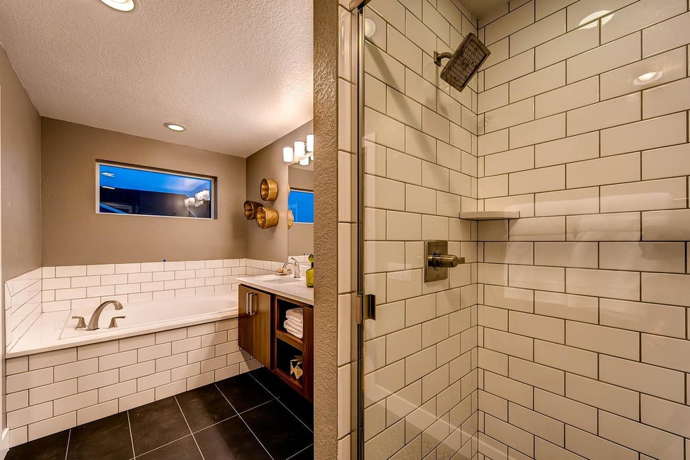 Photo of a mid-sized transitional master bathroom in Denver with flat-panel cabinets, dark wood cabinets, an alcove tub, an alcove shower, a two-piece toilet, white tile, brown walls, slate floors, an undermount sink and solid surface benchtops.