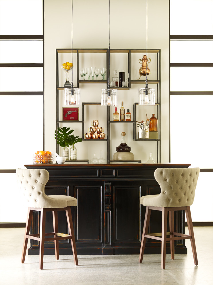Design ideas for a mid-sized eclectic galley seated home bar in Other with recessed-panel cabinets, dark wood cabinets, wood benchtops and concrete floors.