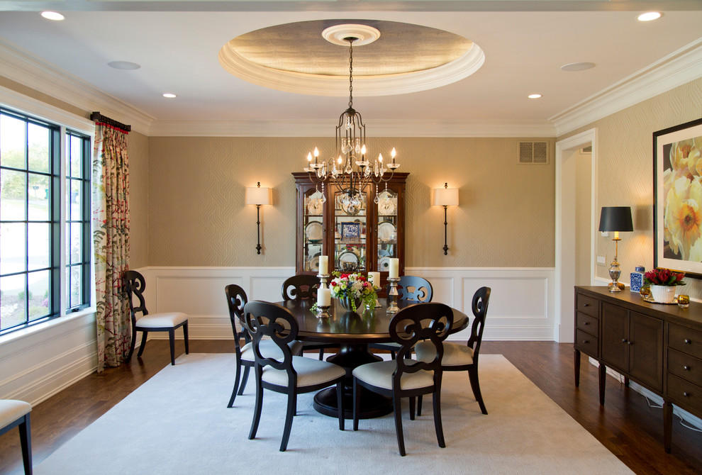 Photo of a large transitional separate dining room in St Louis with beige walls, dark hardwood floors and brown floor.