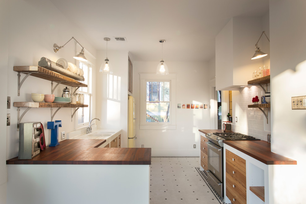 Design ideas for an eclectic kitchen in Austin with stainless steel appliances.