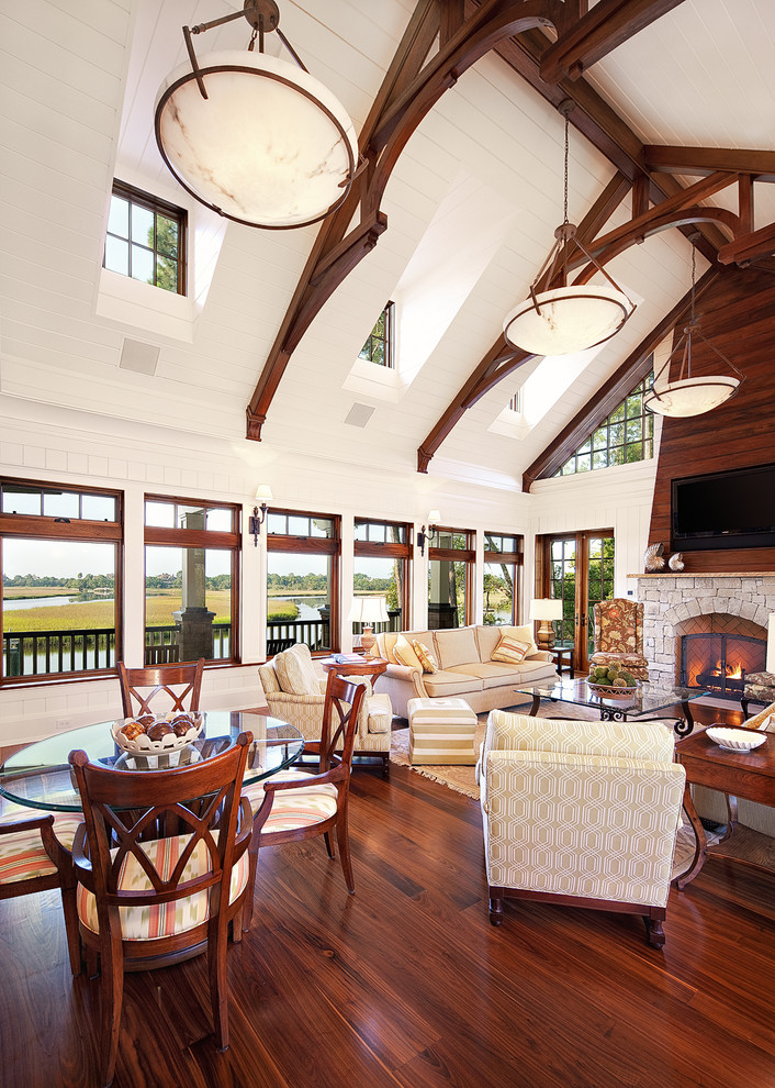 Inspiration for a beach style open concept living room in Charleston with white walls, dark hardwood floors, a standard fireplace and a stone fireplace surround.