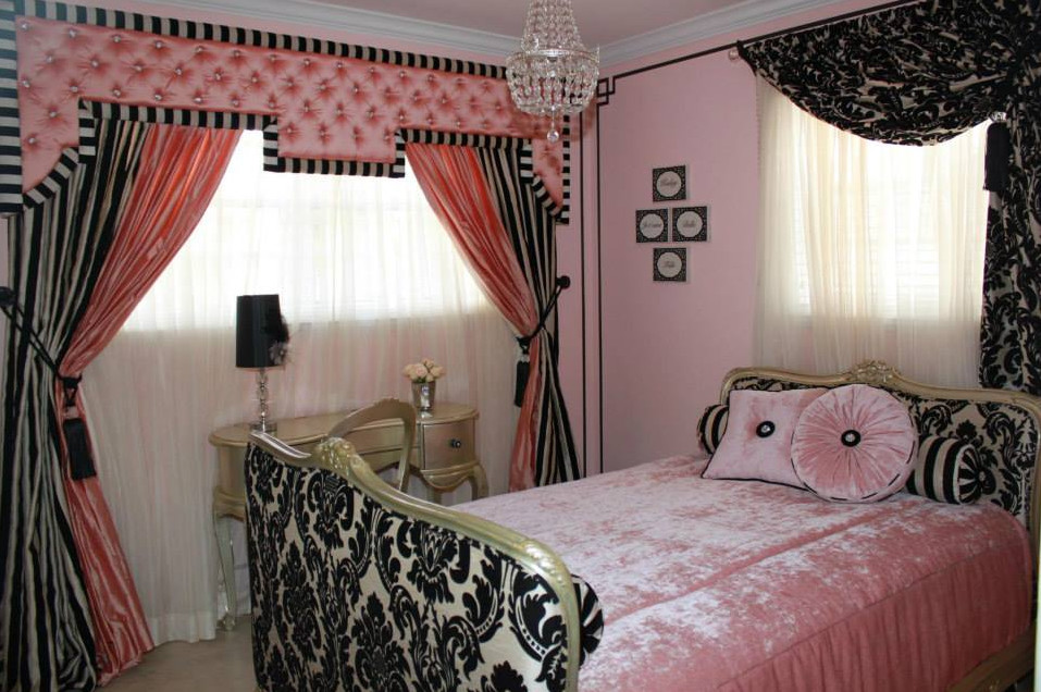 Large traditional guest bedroom in Miami with pink walls and travertine floors.
