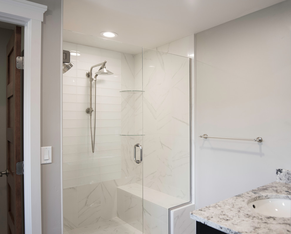 Inspiration for a mid-sized traditional master bathroom in Albuquerque with shaker cabinets, black cabinets, a double shower, a one-piece toilet, blue tile, glass tile, grey walls, ceramic floors, an undermount sink and granite benchtops.
