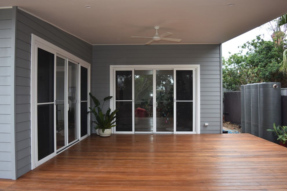 This is an example of a mid-sized beach style backyard deck in Adelaide with a roof extension.