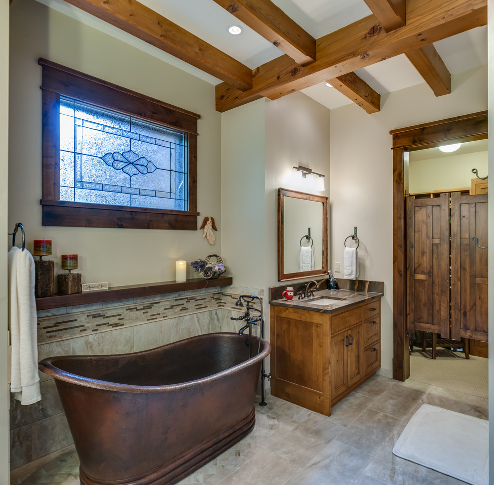 This is an example of a large country master bathroom in Other with recessed-panel cabinets, light wood cabinets, a freestanding tub, an alcove shower, multi-coloured tile, matchstick tile, beige walls, ceramic floors, an undermount sink, marble benchtops, beige floor and a hinged shower door.