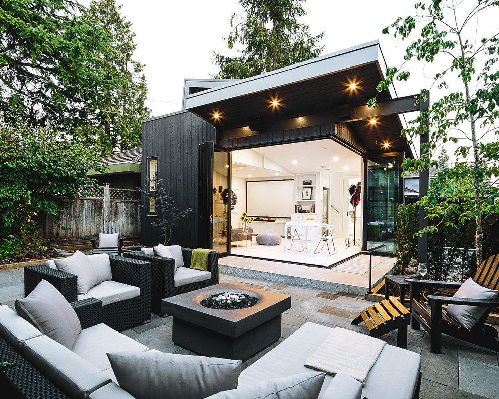 This is an example of a mid-sized scandinavian one-storey black house exterior in Vancouver with wood siding.