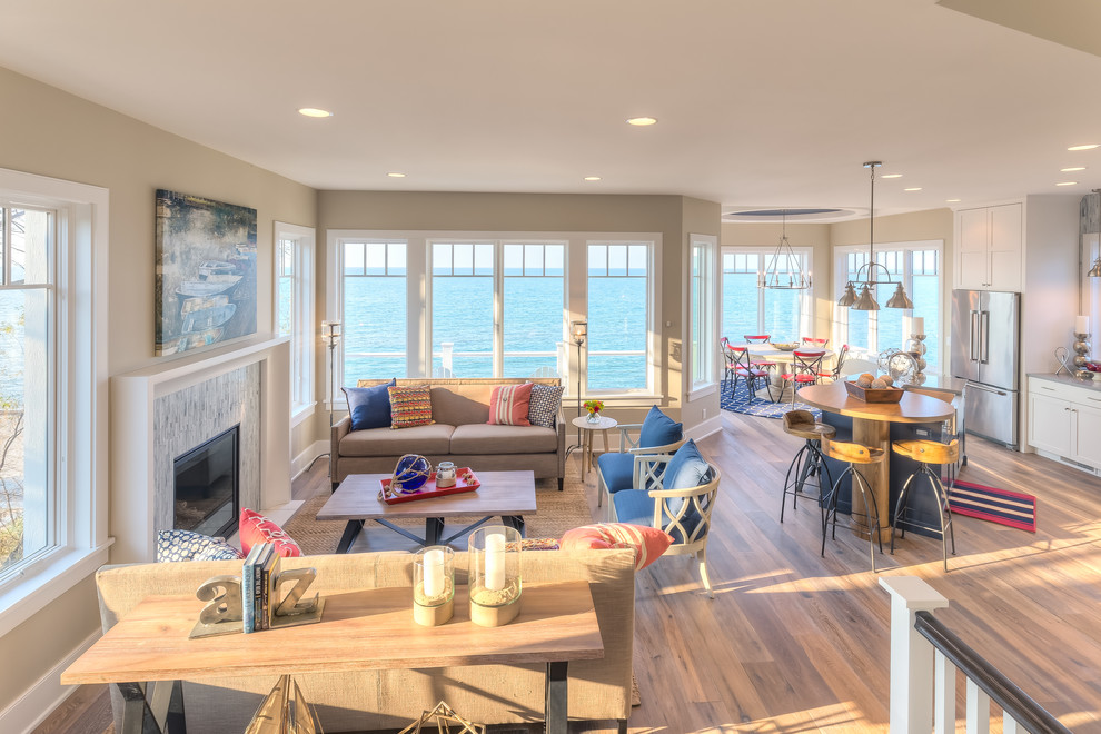 Photo of a large beach style open concept family room in Chicago with a stone fireplace surround.