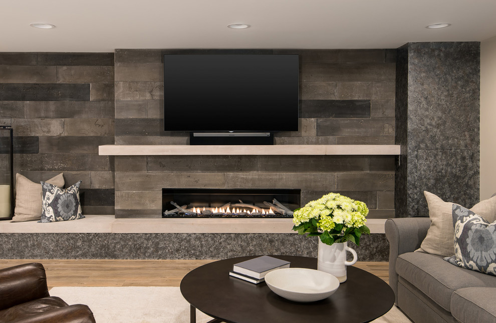 Photo of a mid-sized country look-out basement in Detroit with beige walls, vinyl floors, a ribbon fireplace, a concrete fireplace surround and brown floor.