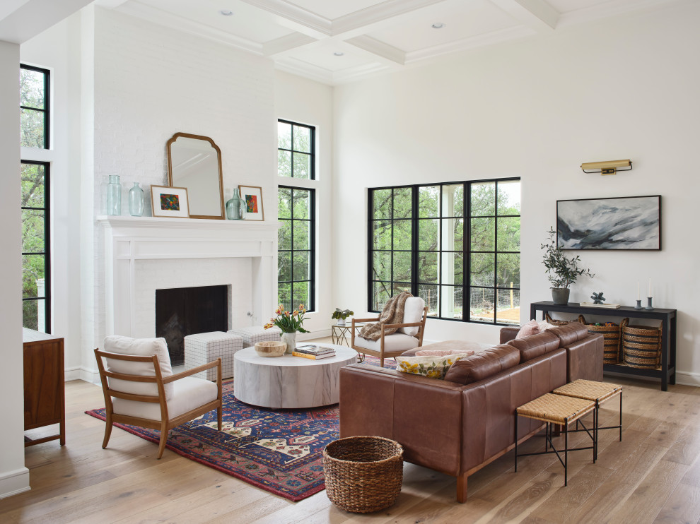 Photo of a large beach style formal open concept living room in Other with white walls, a standard fireplace, a brick fireplace surround and coffered.