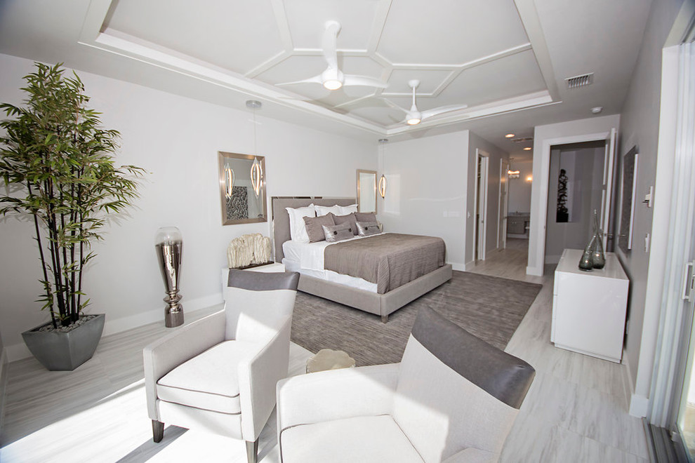 Inspiration for a large modern master bedroom in Miami with white walls and marble floors.