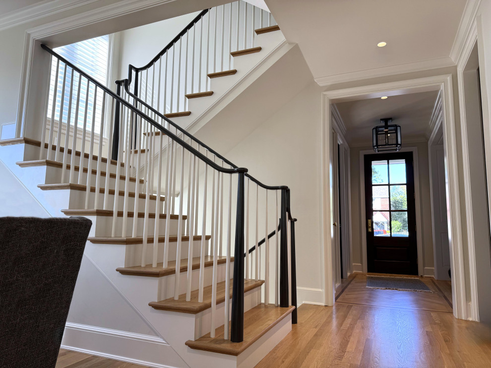Inspiration for a mid-sized transitional wooden u-shaped wood railing staircase remodel in DC Metro with painted risers