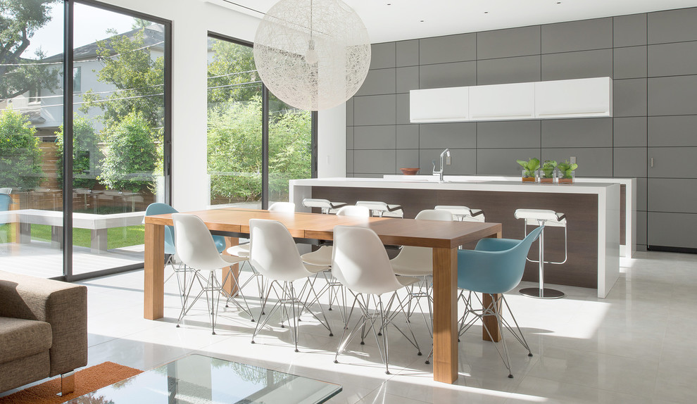 This is an example of a contemporary dining room in Houston with concrete floors.