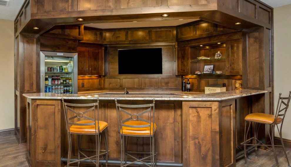Large traditional u-shaped home bar in Other with shaker cabinets, medium wood cabinets, granite benchtops, brown splashback, timber splashback and porcelain floors.