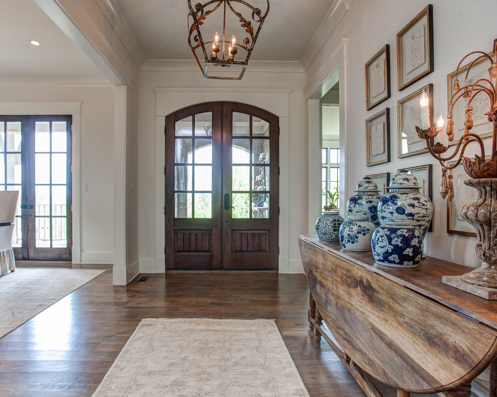 Design ideas for a mid-sized traditional front door in Little Rock with white walls, medium hardwood floors, a double front door and a dark wood front door.