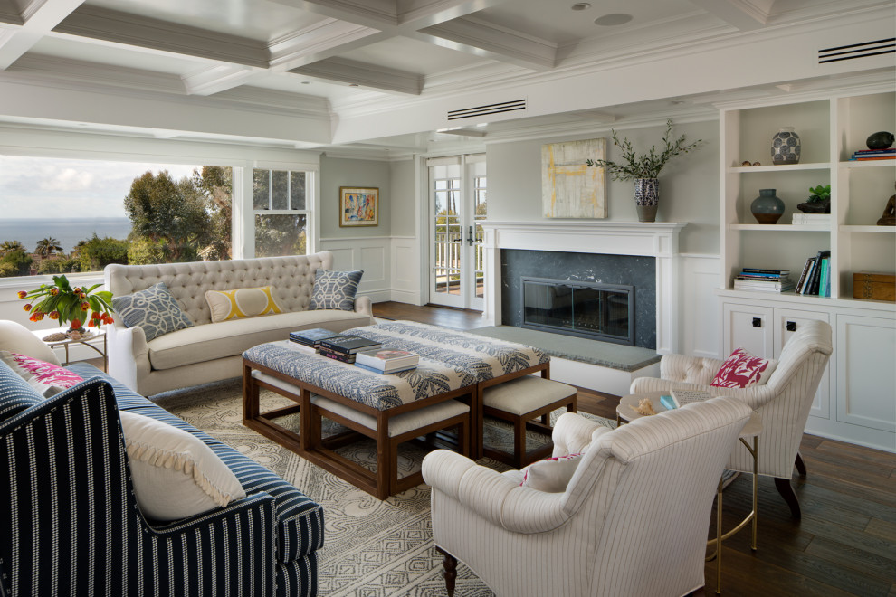 Inspiration for a transitional open concept family room in San Diego with grey walls, dark hardwood floors, a standard fireplace, a stone fireplace surround and brown floor.