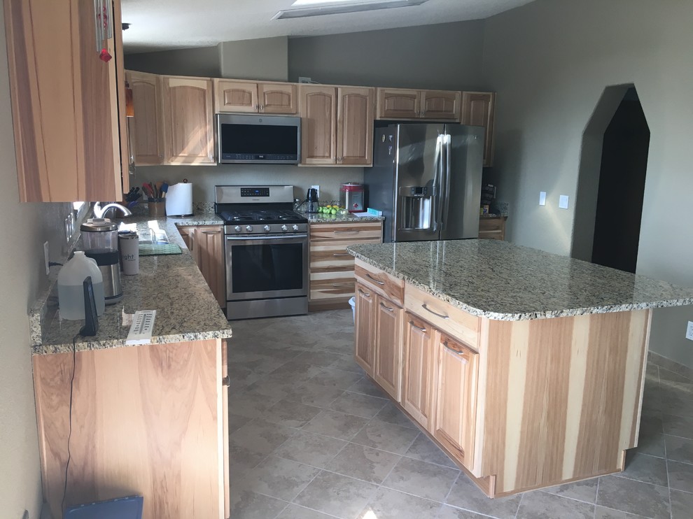 Inspiration for a large rustic l-shaped porcelain tile and beige floor eat-in kitchen remodel in Denver with an undermount sink, raised-panel cabinets, brown cabinets, granite countertops, stainless steel appliances, an island and beige countertops